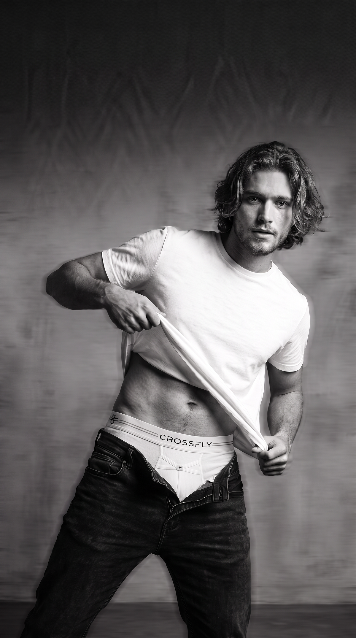 Male model wearing Crossfly men's underwear with black jeans and white tshirt. The boxers show the X-Fly easy fly access