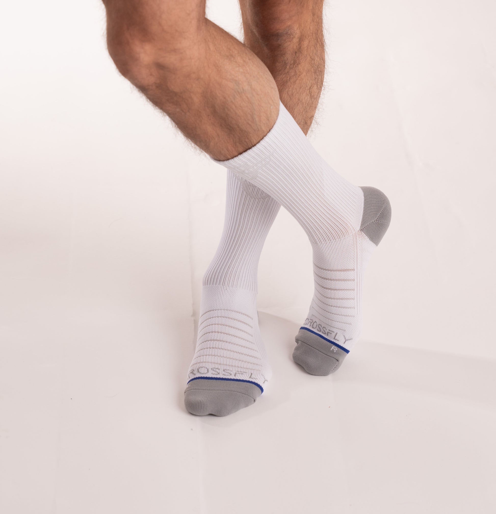 Crossfly men's Hero Crew Socks in white from the Performance series, featuring AirBeams and 180 Hold.